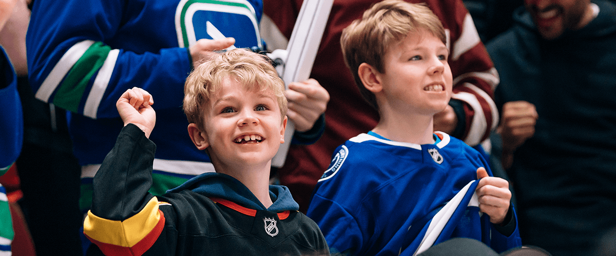 Members of a minor hockey group watch an exciting Vancouver Canucks game.